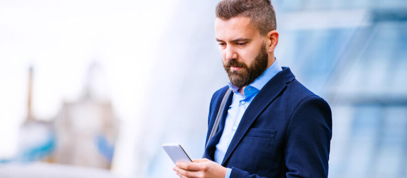 hipster-manager-with-smart-phone-london-city-hall-PBBAF8T